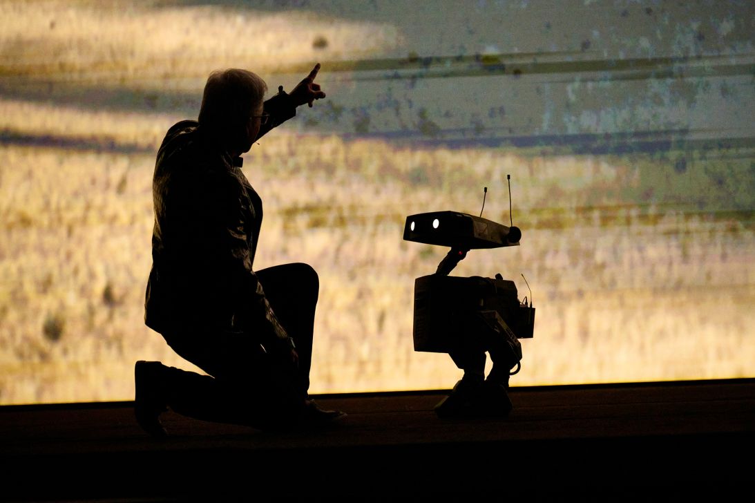 Jensen Huang, chief executive officer of Nvidia Corp., on stage with a small robot during the Nvidia Live event at CES.