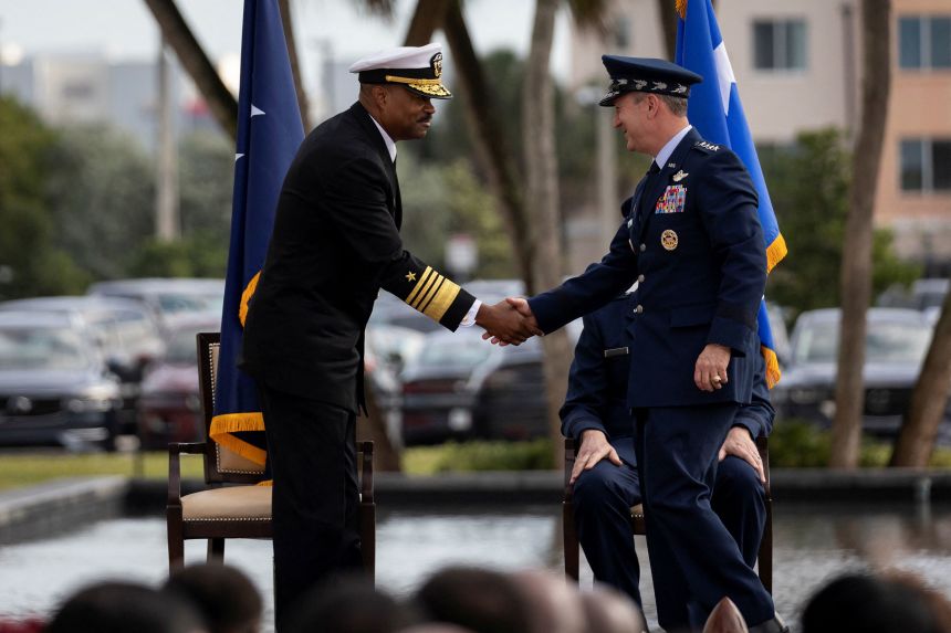Gen. Dan Caine and Navy Admiral Alvin Holsey shake hands during the US Southern Command relinquishment of command ceremony at the SOUTHCOM headquarters in Doral, Florida, on December 12, 2025.
