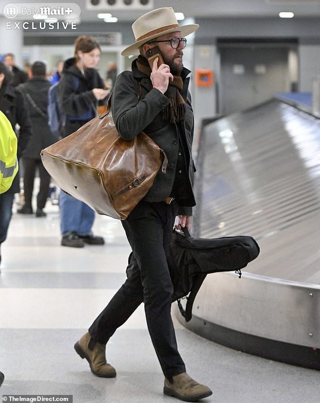 Sutherland's decidedly hipster ensemble - gigantic floppy hat, oversized leather tote, and a guitar in hand - made it look as if he was headed to Coachella music festival, not huddling with attorneys