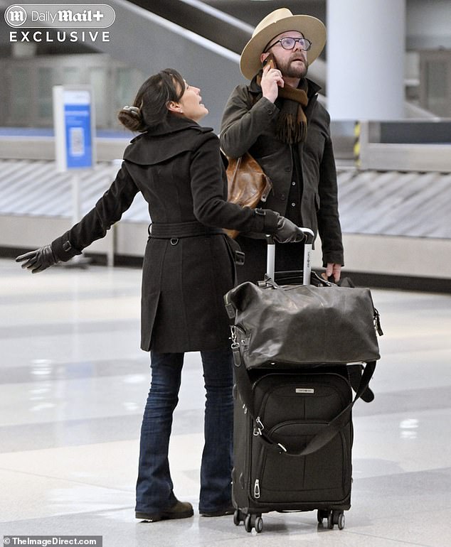 The two-time Emmy winner strutted alongside longtime partner Cindy Vela at New York's JFK airport