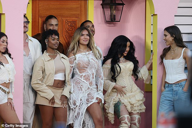 Cardi B (second to left) and Jessica Alba share a glance during the halftime show