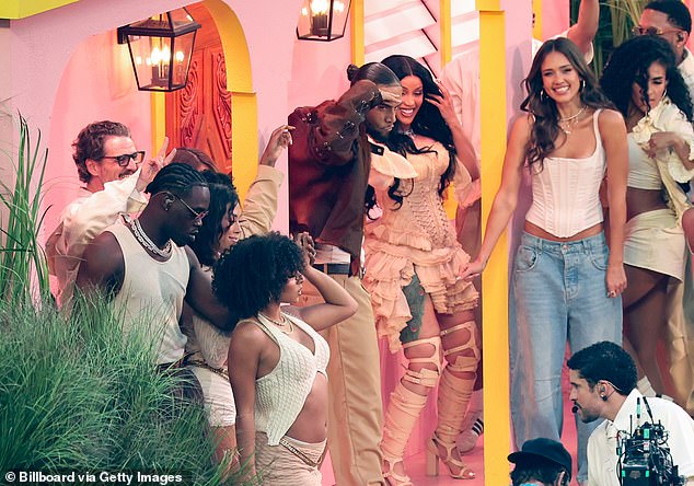Bad Bunny emerged onto a building while celebrities danced under the awning, including Pedro Pascal (L), Cardi B (center) and Jessica Alba (third from the right)