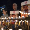 Israelis light the 8th candle of Hanukkah in Hostage Square holding placards bearing the face of Ran Gvili in Tel Aviv, Israel, on Dec. 21, 2025, as they call for the return of his remains. Of the 251 people taken hostage during Hamas's unprecedented October 7, 2023 attack that sparked the war in Gaza, all but the remains of Israeli Ran Gvili have been handed over. (Photo by ILIA YEFIMOVICH / AFP via Getty Images)