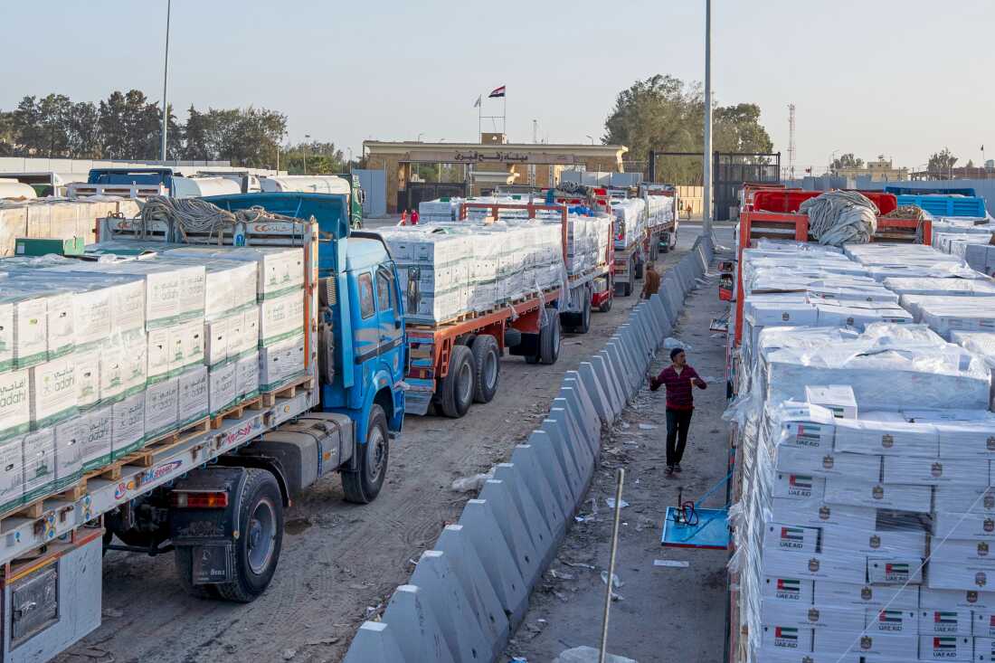 Trucks carrying humanitarian aids line up to enter the Egyptian gate of the Rafah crossing, heading for inspection by Israeli authorities before entering the Gaza Strip, in Rafah, Egypt, Sunday, Feb. 1, 2026.