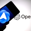 In this photo illustration, a ChatGPT Atlas browser logo is seen displayed on a smartphone with an Open AI logo in the background.