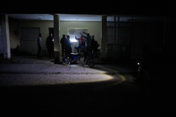 People celebrate a birthday during a scheduled power outage in Santa Cruz del Norte, home to one of Cuba’s largest thermoelectric plants, late Tuesday, Feb. 3, 2026. (AP Photo/Ramon Espinosa)
