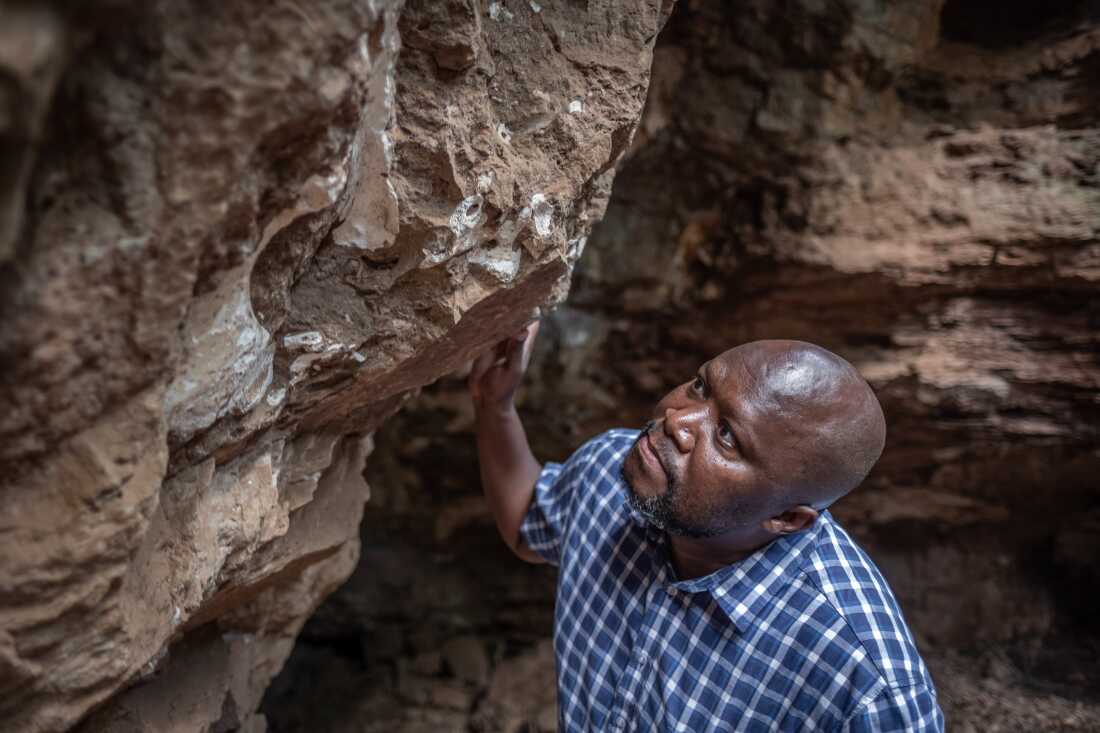 Paleontologist Lazarus Kgasi inspects a piece of fossilised bone during a visit to one of his dig sites in the Cradle of Humankind in Gauteng Province, South Africa. Kgasi began his career working as a hired labourer on the dig sites of others but has since become a highly respected paleontologist and a junior curator at Pretoria's Ditsong National Museum of Natural History. He is one of very few Black paleontologists working in South Africa.