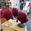 Handmade red "Melt the ICE" hats are on display at Minneapolis yarn store Needle & Skein.