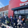 Small group of anti-ICE protesters hold picket signs in front of Target store in Washington, D.C.