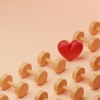 A conceptual image of a grid pattern of yellow dumbbells covering half the screen with a single red heart in between.