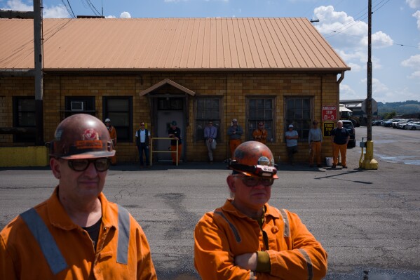 Steelworkers stand at U.S. Steel's Clairton Coke Works in Clairton, Pa., on Tuesday, Aug. 12, 2025, a day after an explosion at the facility killed two workers. (Quinn Glabicki/Pittsburgh's Public Source via AP)