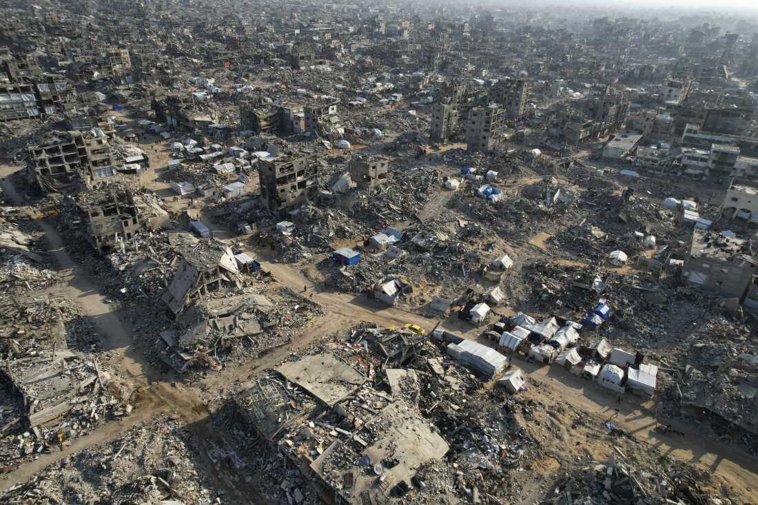 This aerial photo taken by a drone shows light-colored tents set up amid rubble and the empty shells of destroyed buildings in Beit Lahiya, northern Gaza Strip, on February 17, 2025.