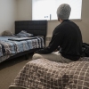 Jefferson, a refugee residing in the Parkview Apartments community in Riverdale, Maryland sits in his bedroom that he shares with his roommate on Feb. 27, 2025.