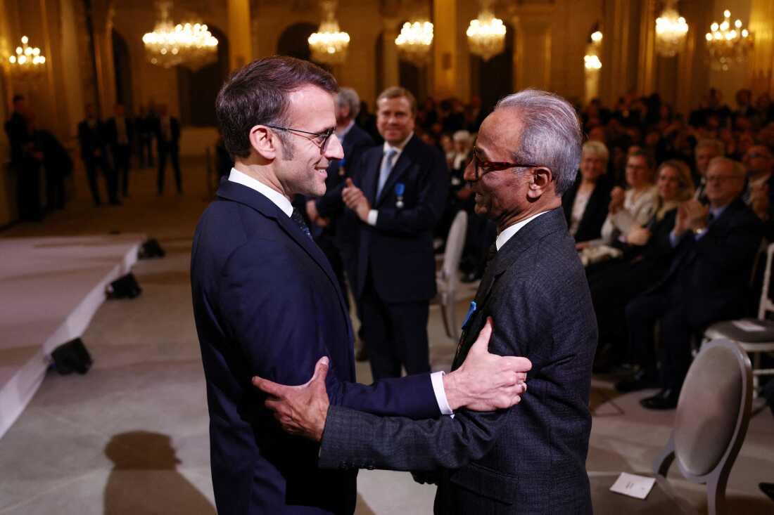 French President Emmanuel Macron awards the Chevalier of the French Order of Merit to Ali Akbar at the Elysee Palace in Paris on Jan. 28, 2026. Akbar, an immigrant from Pakistan, has been selling newspapers around Saint-Germain-des-Pres in the French capital for 50 years.