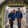 Astronauts and Artemis II mission specialists Christina Koch, left, and Jeremy Hansen, right, exit the International Space Station mockup in the Space Vehicle Mockup Facility on Aug. 26, 2024, at the NASA Johnson Space Center in Houston, Texas.