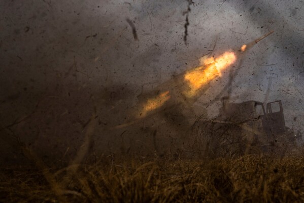 A Ukrainian MSLR BM-21 "Grad" rocket launcher of the 95 Air Assault brigade fires toward Russian positions on the front line near Kreminna, Ukraine, Thursday, March 9, 2023. (AP Photo/Evgeniy Maloletka, File)