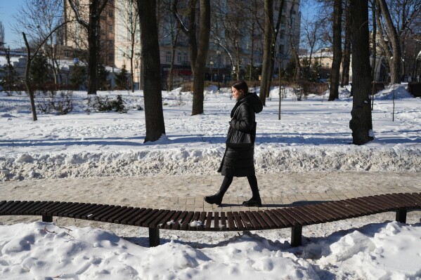 Liliia, 30, whose boyfriend is a prisoner of war, walks through a city park in Kyiv, Ukraine, Saturday, Feb. 21, 2026. (AP Photo/Sergei Grits)