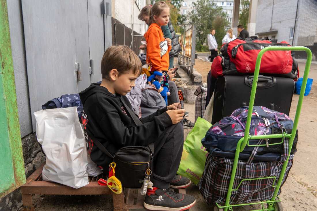 Children from eastern Ukraine's Donetsk region wait to evacuate at a railway station in Lozova, Kharkiv region, on September 26, 2025.