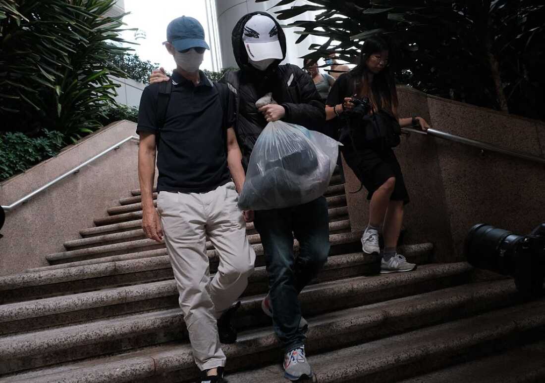 Kwok Yin-sang (L) leaves the High Court after a judge granted him bail in Hong Kong on May 20, 2025.
