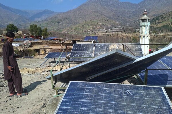 A villager looks at damaged solar plates and a portion following overnight cross border fighting between Pakistan and Afghan forces, at a village in Bajaur, a district of Pakistan's Khyber Pakhtunkhwa province bordering with Afghanistan, Friday, Feb. 27, 2026. (AP Photo)