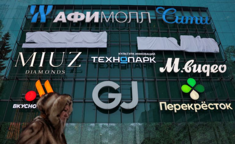 A woman walks past a shopping mall at the Moscow International Business Centre, also known as Moskva-City, in Moscow, Russia February 17, 2026. REUTERS/Ramil Sitdikov