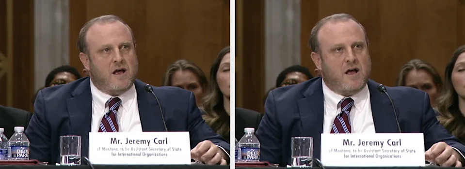 Man in a suit speaks at a hearing, sitting at a panel table with a nameplate reading "Mr. Jeremy Carl."