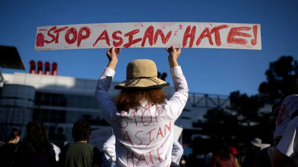 Sally Sha holds up a sign during a Stop Asian Hate rally at Discovery Green in downtown Houston, Texas, on March 20, 2021. - Mark Felix/AFP/Getty Images