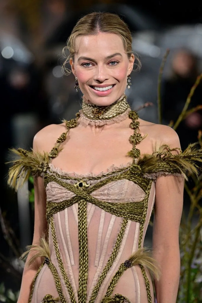 Robbie’s Dilara Findikoglu corset gown was finished with blond braids, too. Anthony Harvey/Shutterstock