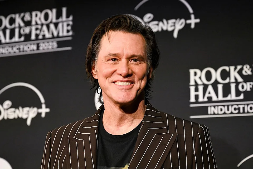 Smiling man in a pinstripe suit at the Rock & Roll Hall of Fame induction event
