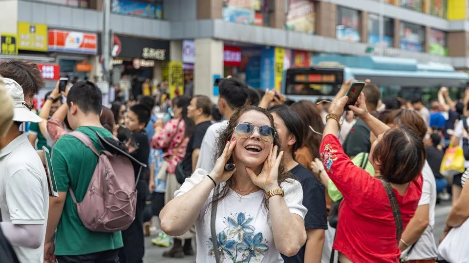 A Serbian tourist has fun at the viewing platform around the Liziba Station of Chongqing Rail Transit in Yuzhong District of southwest China's Chongqing, on October 3, 2025. - Xinhua News Agency/Getty Images
