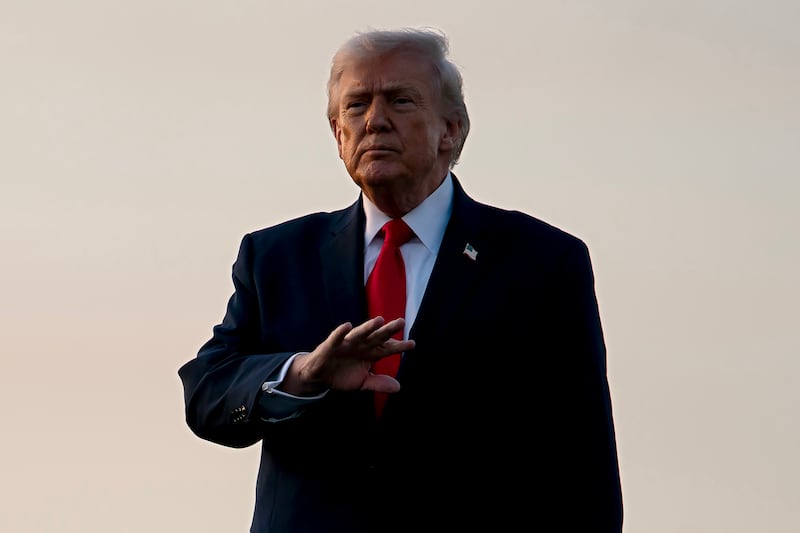 President Donald Trump gestures to members of the media after exiting Air Force One at Palm Beach International Airport on February 13, 2026 in West Palm Beach, Florida.