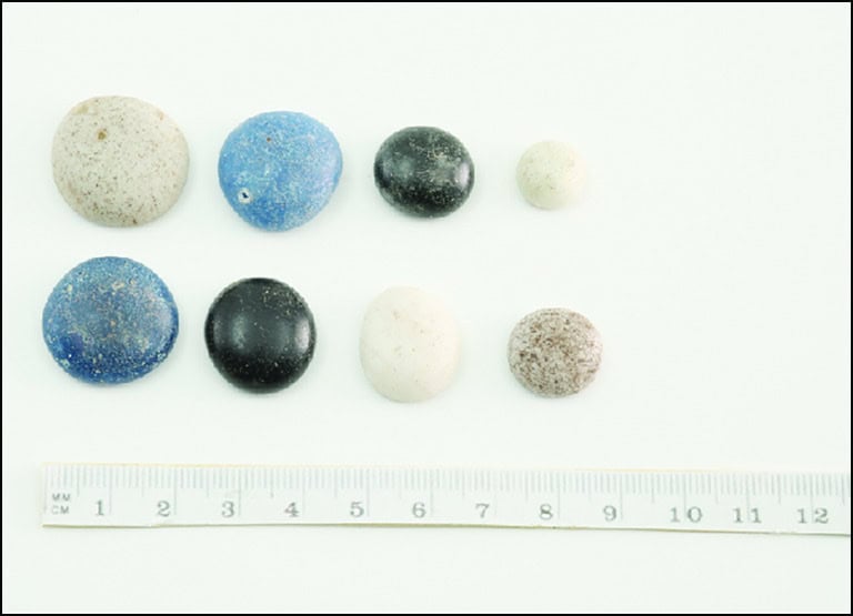 Assorted small spherical objects made of different types of stones or minerals used as game pieces