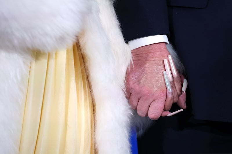 WASHINGTON, DC - JANUARY 28: A detailed view as musician Nicki Minaj (L) and U.S. President Donald Trump hold hands on stage during the Treasury Department's Trump Accounts Summit at Andrew W. Mellon Auditorium on January 28, 2026 in Washington, DC. "Trump Accounts" are a portion of recently passed tax and spending legislation where the federal government will deposit $1,000 into investment accounts for every child born between 2025 and 2028 once parents sign their children up while filing their income taxes.  (Photo by Win McNamee/Getty Images)