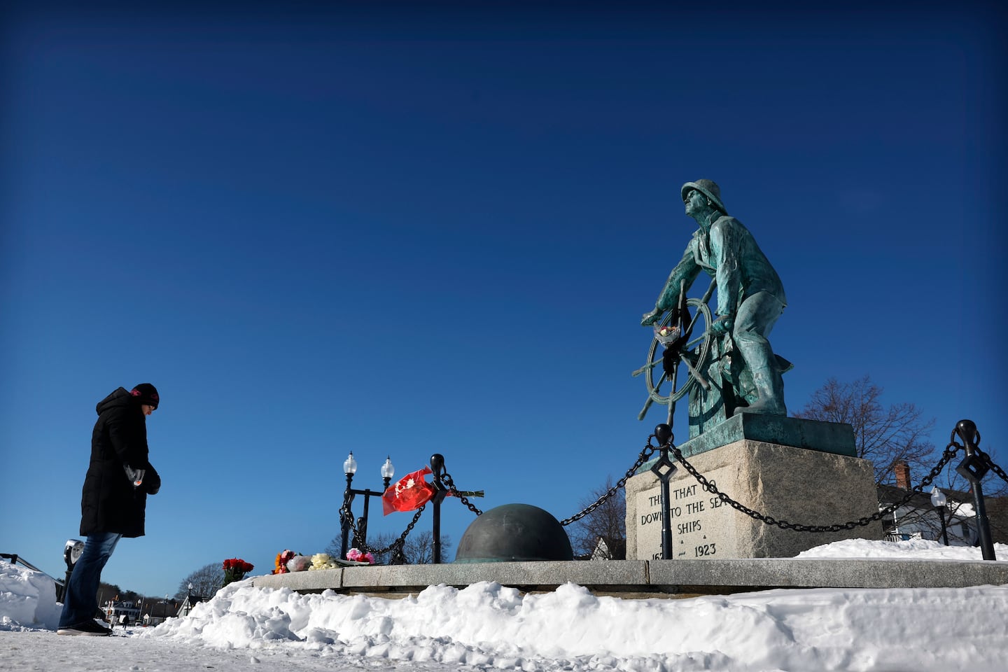 Rebecca Hailey bowed her head in prayer after laying flowers at the Gloucester Fisherman's Memorial. 