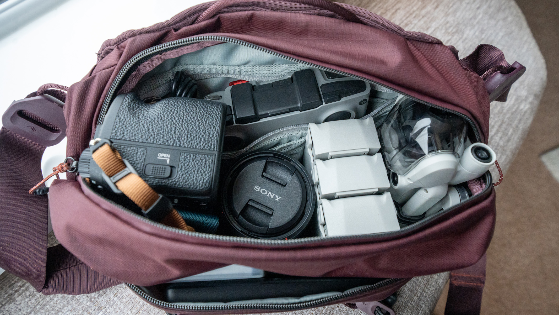 A Peak Design 7L Sling Bag, with a drone and other accessories inside.