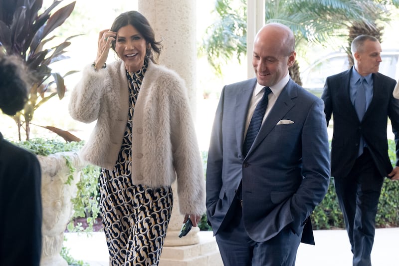 White House Deputy Chief of Staff for Policy Stephen Miller (R) and Secretary of Homeland Security Kristi Noem arrive to attend the wedding of Dan Scavino, White House Deputy Chief of Staff, and Erin Elmore, the Department of State Director of Art in Embassies, at Mar-a-Lago in Palm Beach, Florida, February 1, 2026.