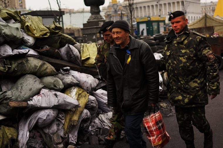 KIEV, UKRAINE - MARCH 19: A man is led away by members of the Ukrainian military in Maidan Square, the site of months of often violent protest that led to the ouster of former Ukrainian president Viktor Yanukovich on March 19, 2014 in Kiev, Ukraine. Tensions in Crimea continue as Russian President Vladimir Putin announced yesterday the annexation of Crimea. Voters in the semiautonomous territory approved a quickly called referendum on separating from Ukraine. (Photo by Spencer Platt/Getty Images)