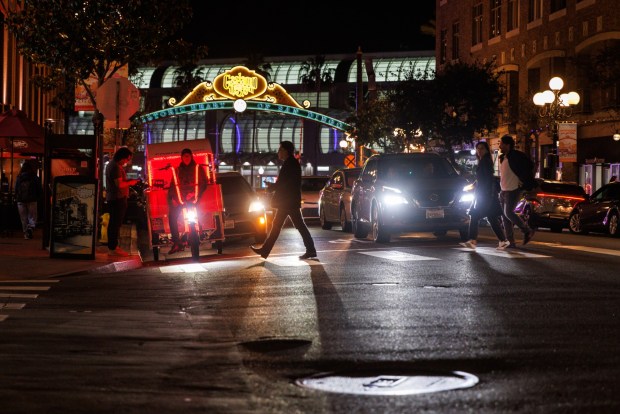 San Diego, California - February 20: Pedestrians cross the street at the Gaslamp Quarter in downtown San Diego on Friday, February 20, 2026. The street was previously closed to vehicular traffic. (Kristian Carreon / The San Diego Union-Tribune)