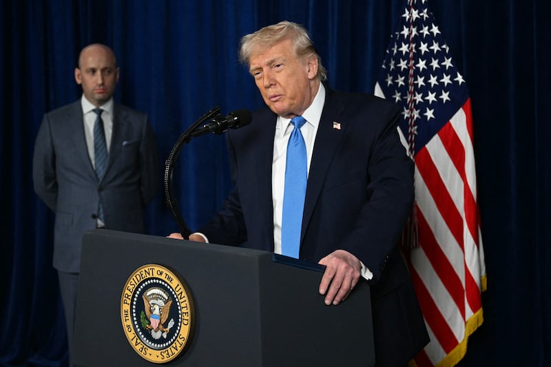 Deputy Chief of Staff Stephen Miller looks on as U.S. President Donald Trump speaks to the press following U.S. military actions in Venezuela, at his Mar-a-Lago residence in Palm Beach, Florida, on January 3, 2026.