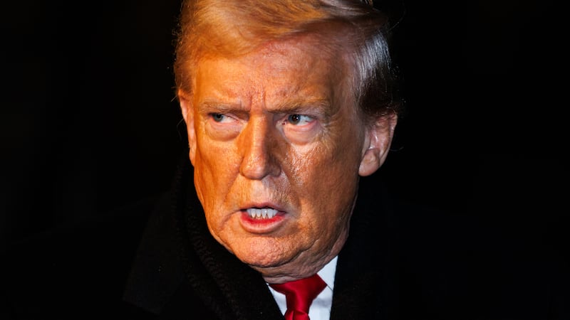 President Donald Trump walks over to reporters to make a brief statement before departing from the South Lawn of the White House in Marine One on January 20, 2026 in Washington, DC.