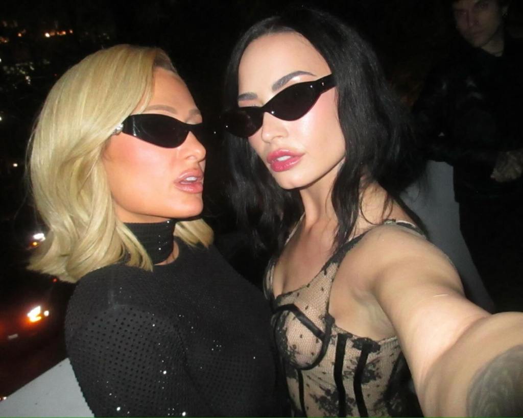 Paris Hilton and Demi Lovato serve face for a snap.