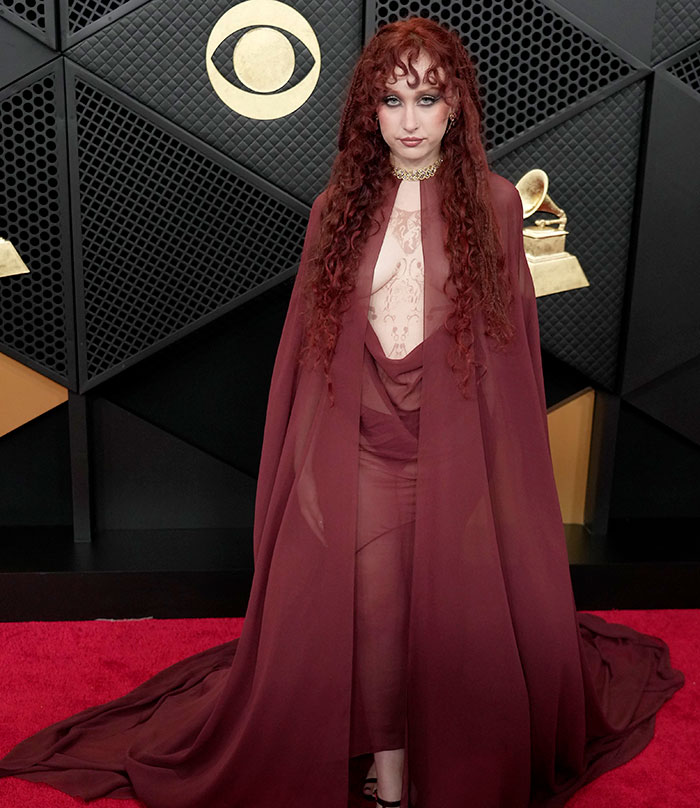 Chappell Roan in a sheer maroon gown and cape at the Grammys, breaking silence after her controversial look sparked outrage. Chappell Roan in a sheer maroon gown and cape at the Grammys, breaking silence after her controversial look sparked outrage.