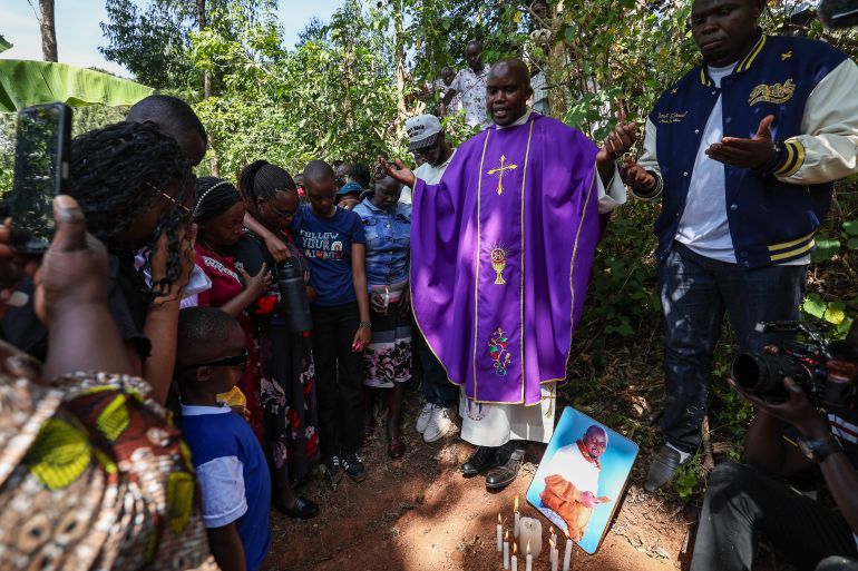 epa12707173 A Catholic priest (C) leads a prayer during a symbolic funeral service of Charles Waithaka Wangari 31yrs, who was killed while fighting in Russia, next to a symbolic grave after failing to retrieve his body from Russia for burial at their rural Mukurwe-ini village, in Nyeri, Kenya, 05 February 2026. Waithaka is among the many Kenyans and other African youths who have fallen victims after being lured for lucrative jobs in Russia but later are forcefully recruited into the Russian military to fight against Ukraine Army in the frontline in the ongoing Ukraine-Russia war. According to a briefing from Kenya’s Ministry of Foreign and Diaspora Affairs of November 2025, recruitment exercises in Russia have reportedly expanded to include African nationals, including Kenyans since the start of the conflict between Russia and Ukraine in 2022. Reports suggest that over two hundred Kenyans may have joined the Russian military after being lured by promises of ordinary jobs, only to end up on the frontline in Ukraine. EPA/DANIEL IRUNGU