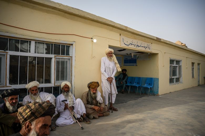 Community health council members sit in front of the clinic of Larga, in Muqur district of Ghazni province, Afghanistan, which closed due to US funding cuts at the end of January 2025.