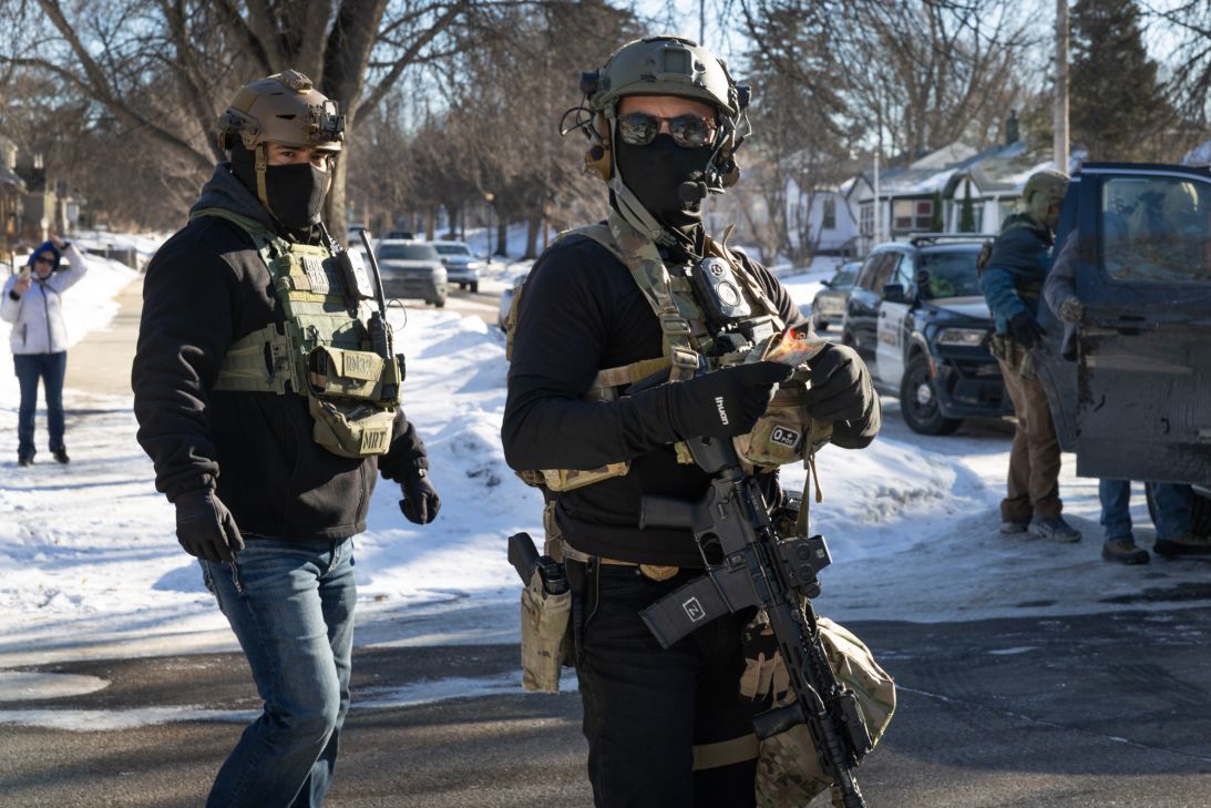 Federal immigration agents stand guard after one of their vehicles was involved in a crash while making an apprehension on January 31, 2026 in St. Paul, Minnesota.