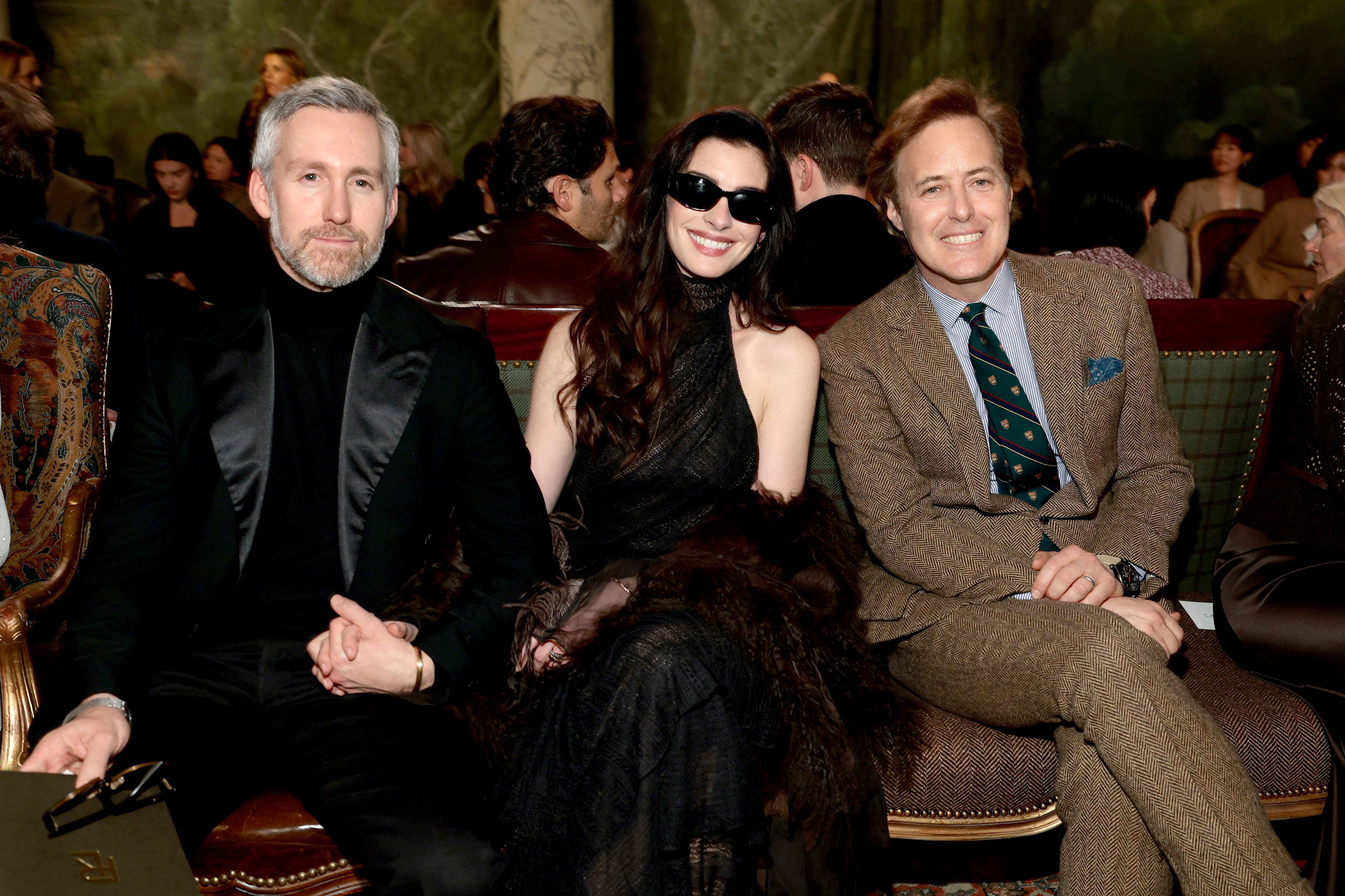 Adam Shulman, Anne Hathaway and David Lauren attend the Ralph Lauren fashion show during New York Fashion Week on February 10, 2026 in New York City.