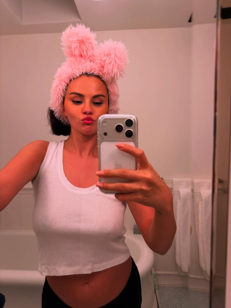 Selena Gomez snaps a mirror selfie in a fuzzy bunny headband.