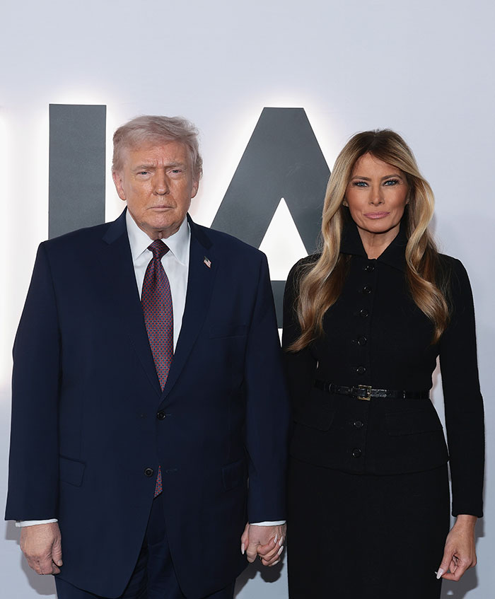 Donald Trump and Melania Trump standing together at an event, related to Melania documentary and theater's clap back. Donald Trump and Melania Trump standing together at an event, related to Melania documentary and theater's clap back.