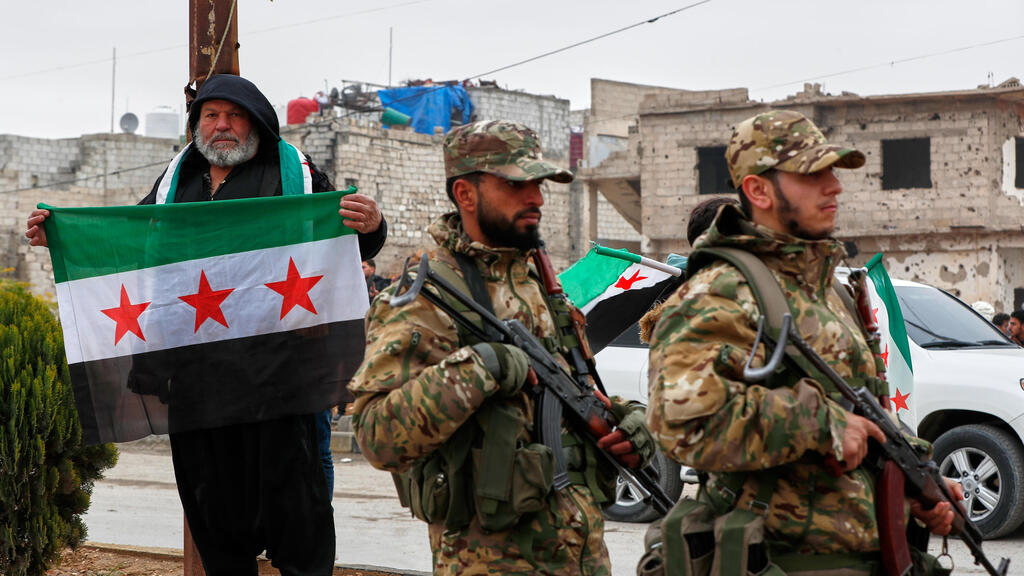 Forces of Syria’s new regime in the suburbs of Damascus (Photo: AP Photo/Omar Sanadiki) סוריה חגיגות שנה ל הפיכה ולהפלת משטר אסד פרברי דמשק לפני מצעד צבאי
