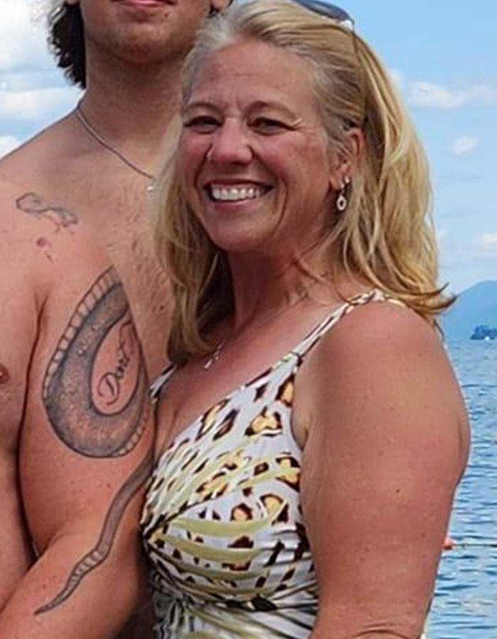 Woman smiling near water with tattooed man, related to police discovering disturbing detail about ice rink attacker family. Woman smiling near water with tattooed man, related to police discovering disturbing detail about ice rink attacker family.